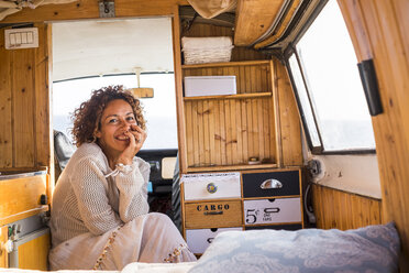 Spain, Tenerife, portrait of laughing woman sitting in van - SIPF01715
