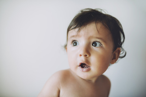 Surprised baby girl on white background stock photo