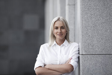 Portait of confident businesswoman leaning against a wall - VPIF00060