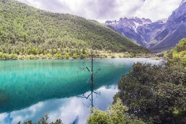 China, Yunnan, Lijiang, lake and Jade Dragon Snow Mountain in background - THAF02016