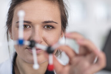 Scientist working in lab holding molecular structure - ZEF14599