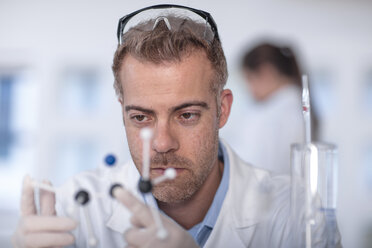 Scientist working in lab holding molecular structure - ZEF14607