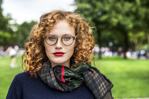 Portrait of redheaded young woman wearing glasses - FMKF04491