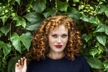 Portrait of redheaded young woman with red lips - FMKF04493