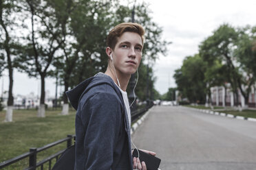 Young man with cell phone and earphones in the city - VPIF00078