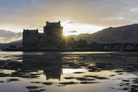 UK, Scotland, Dornie, Loch Duich, Eilean Donan Castle at sunset stock photo