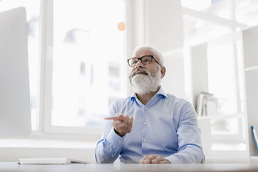 Mature man with beard and glasses working at desk - JOSF01705