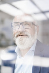 Portrait of mature man behind windowpane - JOSF01716