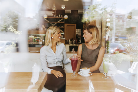 Two happy young women in a cafe stock photo