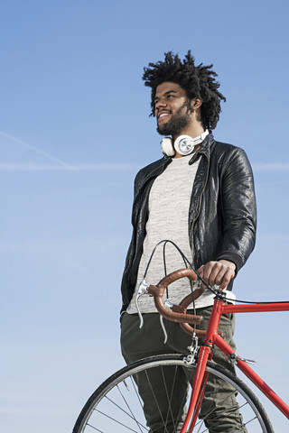 Smiling man with bicycle outdoors stock photo