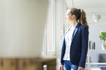 Businesswoman looking out of window - JOSF01765