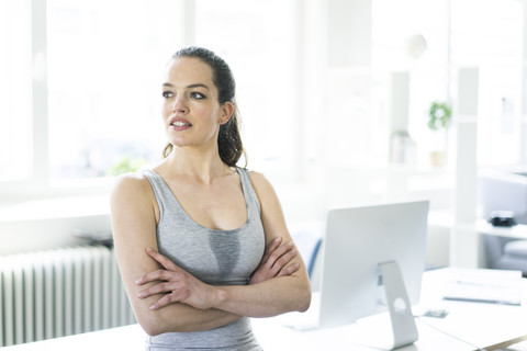 Woman sitting in office after workout stock photo