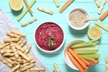 Bowl of beetroot hummus, sesame, carrot and celery crudites and breadsticks - RTBF01001