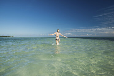 USA, Florida, Key West, Bahia Honda State Park, back view of woman wading into the sea - CHPF00432