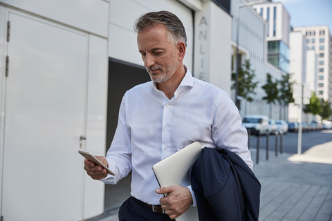 Businessman looking at cell phone stock photo