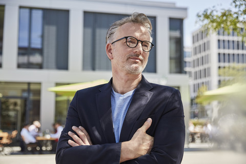 Portrait of businessman with arms crossed stock photo