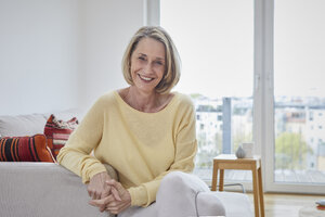 Portrait of happy mature woman at home on the sofa - RBF06037