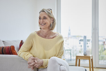 Portrait of smiling mature woman at home on the sofa - RBF06039