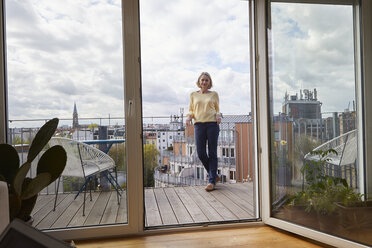 Mature woman at home standing on balcony - RBF06056