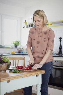 Ältere Frau bereitet einen Salat in der Küche zu - RBF06071