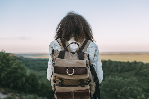 Back view of teenage girl with backpack in nature stock photo