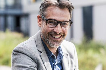 Portrait of smiling businessman with glasses - UUF11729