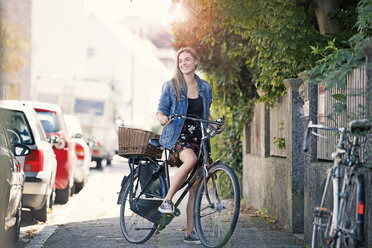 Young woan with bicycle in the city - MAEF12422