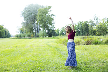 Young woman dancing on grass - MAEF12445