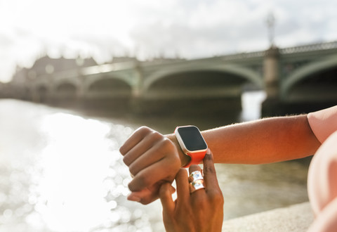 UK, London, close-up of woman using her smartwatch near Westminster Bridge stock photo