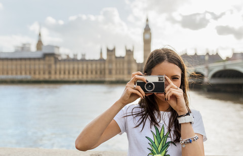 UK, London, beautiful woman taking a picture near Westminster Bridge stock photo