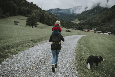 Austria, Vorarlberg, Mellau, mother carrying toddler on shoulders on a trip in the mountains - DWF00314