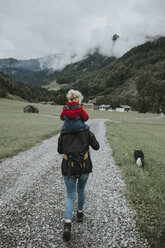 Österreich, Vorarlberg, Mellau, Mutter trägt Kleinkind auf den Schultern bei einem Ausflug in die Berge - DWF00316