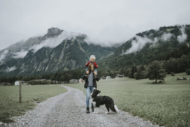 Österreich, Vorarlberg, Mellau, Mutter trägt Kleinkind auf den Schultern bei einem Ausflug in die Berge - DWF00317