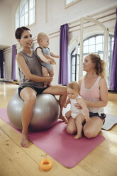 Mothers and babies in exercise room - MFF04023