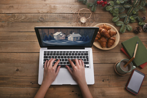 Woman using laptop at Christmas time, top view stock photo