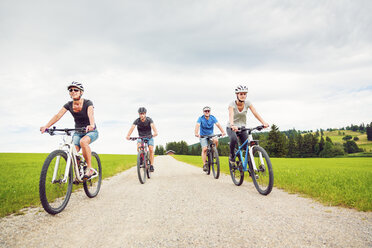 Germany, Bavaria, Pfronten, family riding mountain bikes in the countryside - PNPF00036