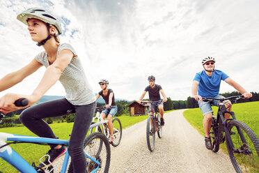 Germany, Bavaria, Pfronten, family riding mountain bikes in the countryside - PNPF00038