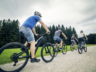 Germany, Bavaria, Pfronten, family riding mountain bikes in the countryside - PNPF00041
