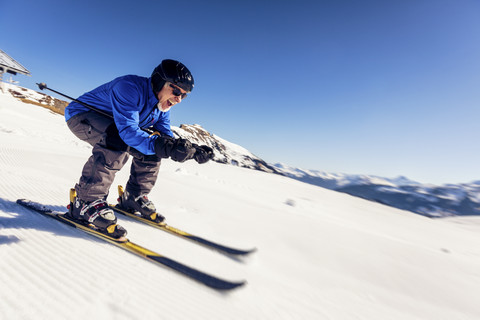 Austria, Damuels, happy senior man skiing in winter landscape stock photo