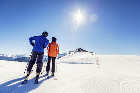 Austria, Damuels, couple with skiers in winter landscape stock photo