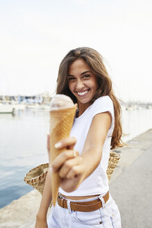 Portrait of smiling young woman holding ice cream cone - JRFF01461