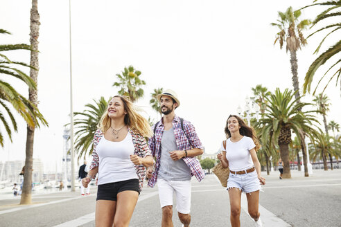 Spain, Barcelona, three tourists on the move in the city - JRFF01466