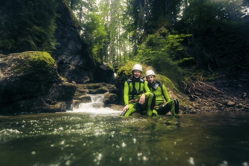 Germany, Bavaria, Allgaeu, young couple canyoning in Ostertal - PNPF00082