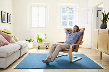 Man relaxing at home sitting in arm chair - PDF01324
