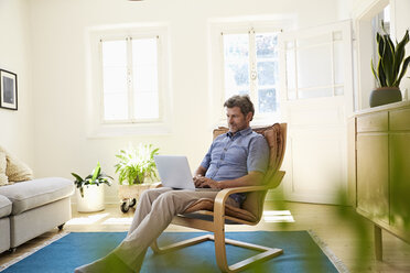 Man working at home using laptop - PDF01326