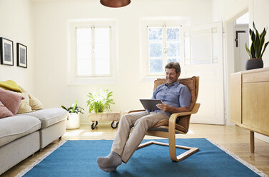 Man working at home using digital tablet - PDF01327