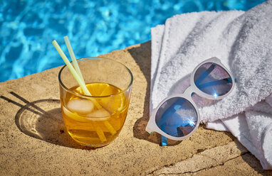 Glass of Crodino, sunglasses and towel at the poolside - DIKF00283