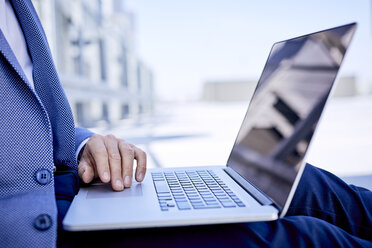 Close-up of businessman using laptop outdoors - BSZF00042