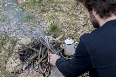 Man preparing campfire - ZOCF00504