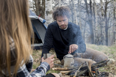 Couple camping in forest - ZOCF00506